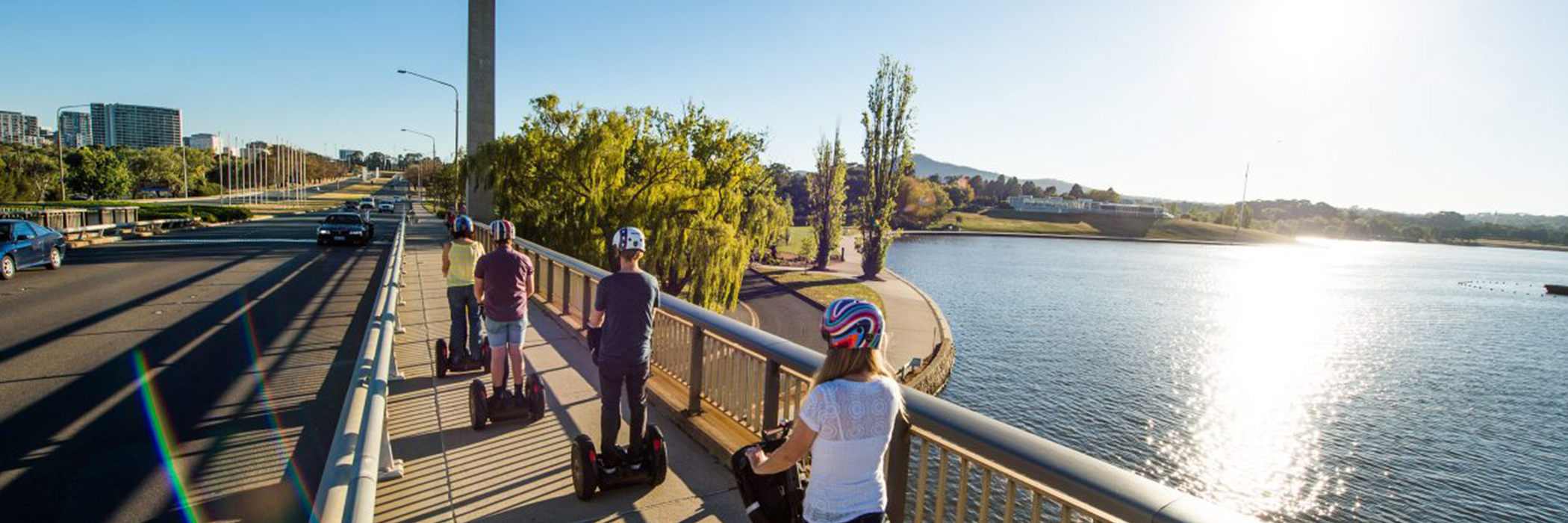 Group of children riding segways across Lake Burley Griffin. Family activities in Canberra.